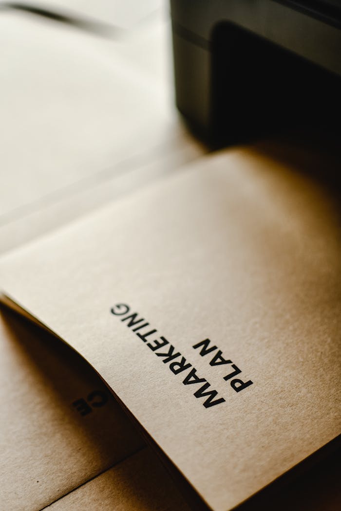 Detailed view of the words Marketing Plan printed on brown paper, conceptual and business themed.